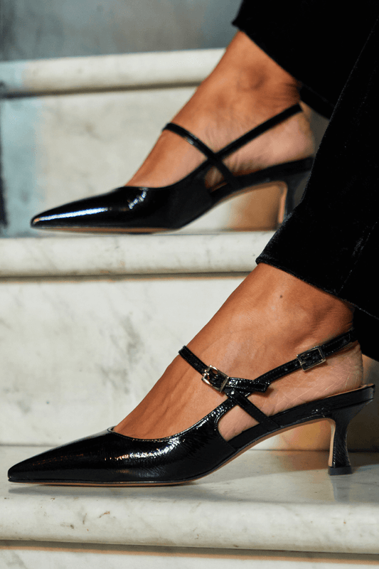 talons slingback noirs brillants à bout effilé.